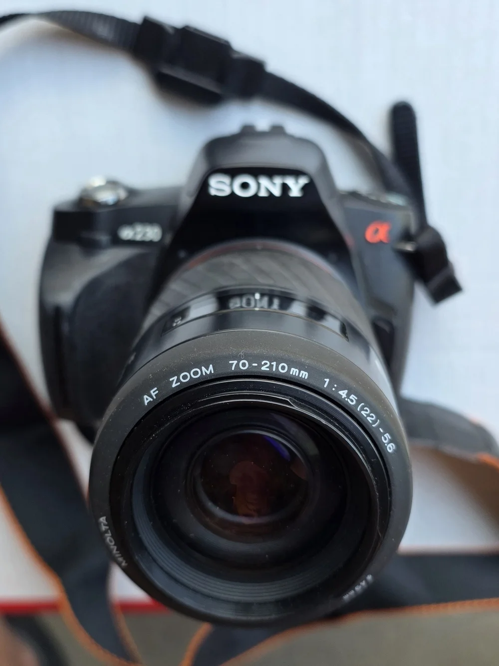 Sony Black DSLR Camera with Black Bag and Orange Interior